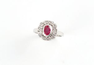 An Art Deco style platinum ruby & diamond ring, the oval cushion cut ruby weighing approximately 0.