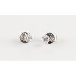 A pair of 18ct white gold diamond stud earrings, the round brilliant cut diamonds weighing