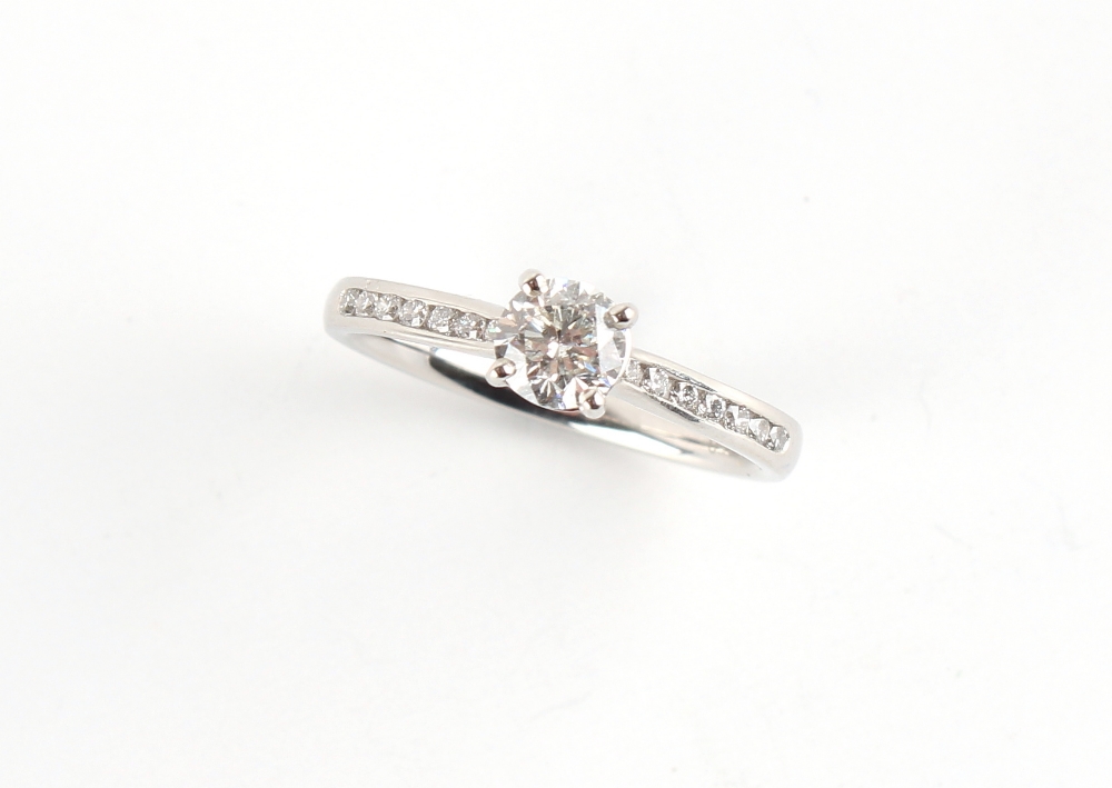 A platinum diamond single stone ring, the W.G.I. certificated round brilliant cut diamond weighing