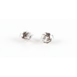 A pair of 18ct white gold diamond stud earrings, the emerald cut diamonds weighing approximately 0.