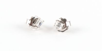 A pair of 18ct white gold diamond stud earrings, the emerald cut diamonds weighing approximately 0.
