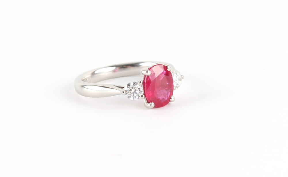 A platinum ruby & diamond three stone ring, the oval cushion cut ruby weighing approximately 1.51 - Image 2 of 2