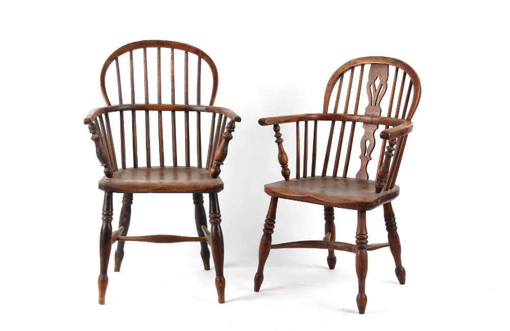 A mid 19th century elm seated Windsor elbow chair with turned legs & crinoline stretcher; together