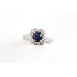 A platinum Ceylon sapphire & diamond ring, the cushion cut sapphire weighing approximately 1.23