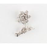 An unmarked white gold diamond floral spray brooch, set with round brilliant cut & baguette cut