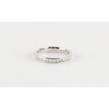 A platinum diamond half eternity ring, the twenty-one round cut diamonds weighing a total of
