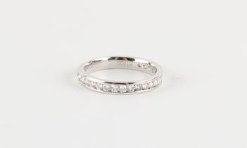 A platinum diamond half eternity ring, the twenty-one round cut diamonds weighing a total of