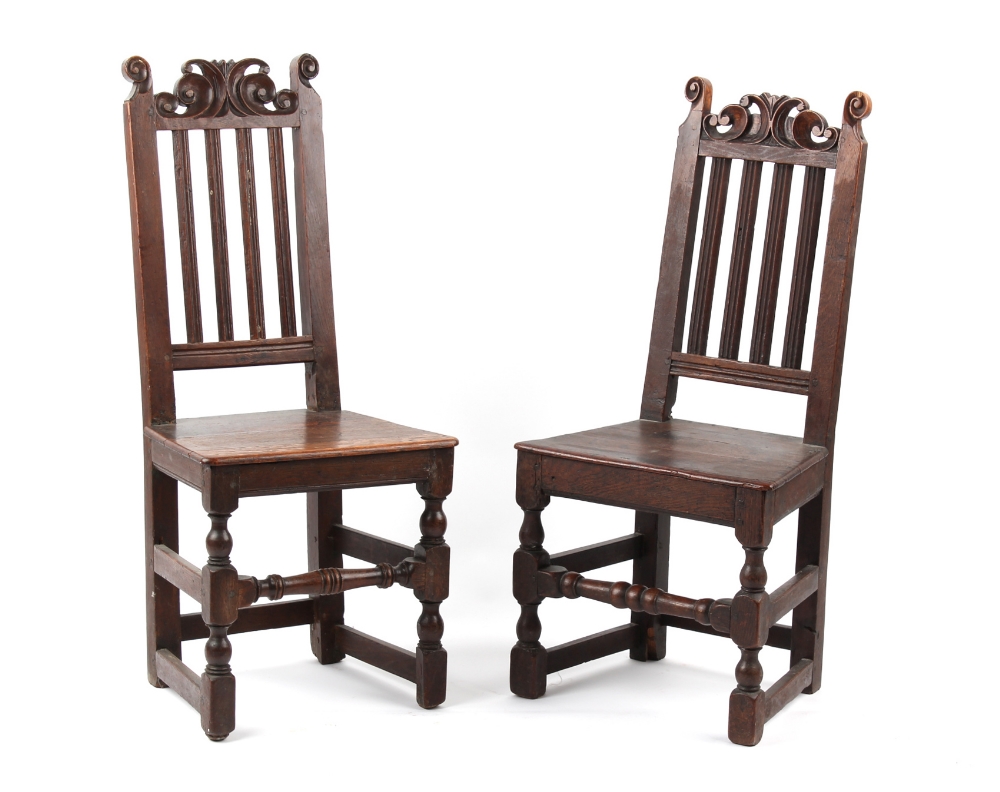 Property of a gentleman - two very similar late 17th century oak high-back chairs with carved scroll