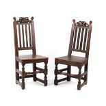 Property of a gentleman - two very similar late 17th century oak high-back chairs with carved scroll