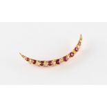 A late 19th / early 20th century 15ct yellow gold ruby & diamond crescent brooch, set with nine