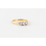 An 18ct yellow gold diamond three stone ring, the round brilliant cut diamonds weighing an estimated