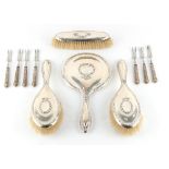 Property of a deceased estate - a silver backed four piece dressing table hand mirror & brush set;