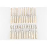 Property of a lady - a set of twelve each early 20th century silver dessert knives & forks with