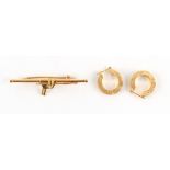Property of a deceased estate - an 18ct gold bar brooch modelled as a spear gun, marked 750 (