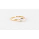 An 18ct yellow gold diamond single stone ring, the round brilliant cut diamond weighing