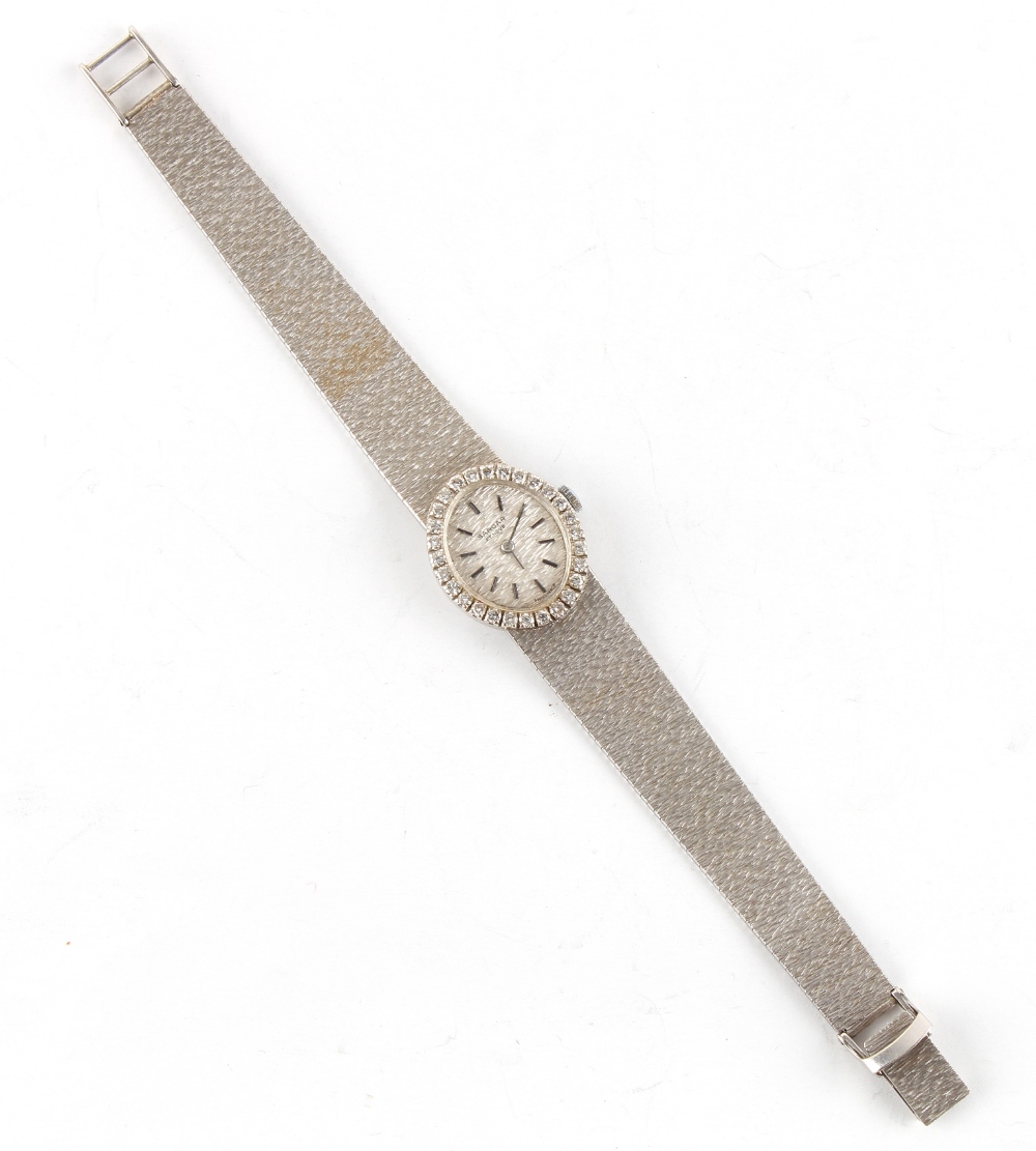 Property of a lady - a lady's Swiss Sarcar 18ct white gold oval cased wristwatch with diamond bezel,