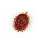 An unmarked gold (tests 9ct) oval cameo pendant depicting the head of Ceres, with seed pearl border,