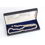 Property of a deceased estate - a cultured pearl single strand necklace, the uniform pearls