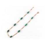 Property of a lady - a 9ct gold & malachite bean necklace, 17.75ins. (45cms.) long, approximately