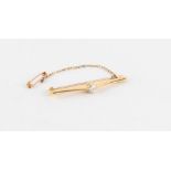 Property of a lady - an unmarked 18ct yellow gold (tested) diamond single stone bar brooch, the