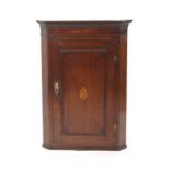 Property of a gentleman - a George III oak & mahogany corner wall cabinet, with inlaid urn motif,