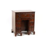 Property of a gentleman - a small walnut kneehole desk with brushing slide, late 19th / early 20th