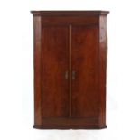 Property of a lady - a George III mahogany & boxwood strung two-door corner cabinet, 45.25ins. (