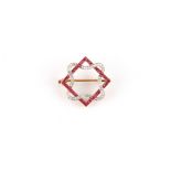 An early 20th century ruby & diamond ribbon & square frame brooch, with square cut rubies & rose cut