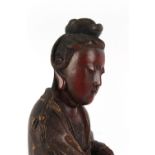 A Chinese carved & painted figure of Guanyin, 19th century, 21.05ins. (53.5cms.) high.