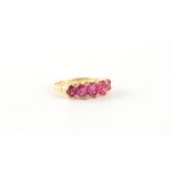 An unmarked yellow gold (tests 18ct) certificated Burmese ruby five stone ring, the five unheated