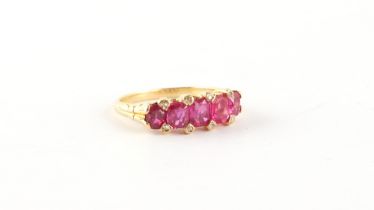 An unmarked yellow gold (tests 18ct) certificated Burmese ruby five stone ring, the five unheated