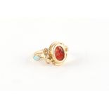 A yellow gold (tests 14ct) carved carnelian intaglio ring depicting a winged classical figure, in