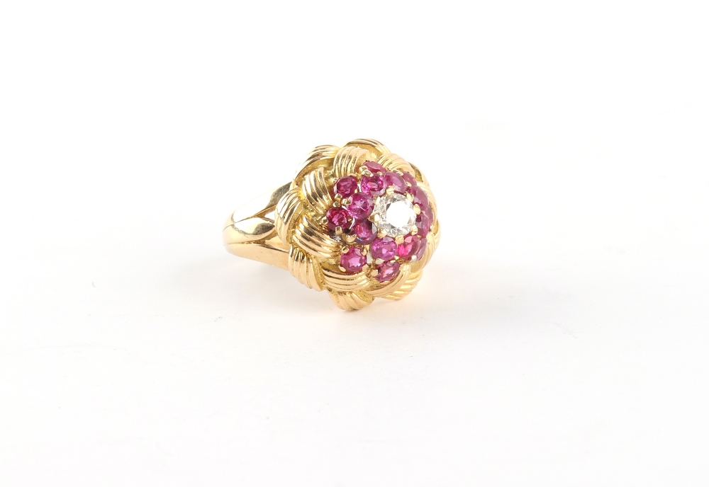 An unmarked yellow gold (tests 18ct) ruby & diamond knot ring, the round cut rubies weighing an