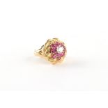 An unmarked yellow gold (tests 18ct) ruby & diamond knot ring, the round cut rubies weighing an