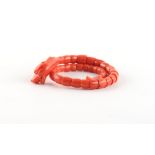 A carved coral articulated snake bracelet, approximately 19.1 grams.