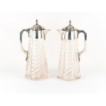 Property of a gentleman - a pair of Victorian silver mounted claret jugs of spiral fluted tapering