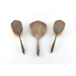 Property of a deceased estate - a silver three piece dressing table hand mirror & brush set, with