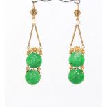 A pair of Chinese high carat yellow gold carved apple green jadeite & pearl pendant earrings, each