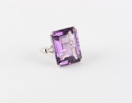 A very good large amethyst ring, the emerald cut amethyst of vibrant colour & weighing approximately