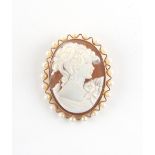 Property of a lady - a 9ct gold framed carved shell cameo brooch, with seed pearl border, 48mm long,
