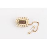 Property of a lady - an early Victorian unmarked yellow gold seed pearl mourning brooch with braided