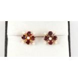 A pair of 9ct yellow gold garnet & pearl flowerhead earrings, with post & butterfly fastenings, each