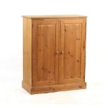 Property of a gentleman - a modern pine panelled two-door cupboard, 36.25ins. (92cms.) wide (