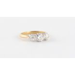 An 18ct yellow gold diamond three stone ring, the three round brilliant cut diamonds weighing