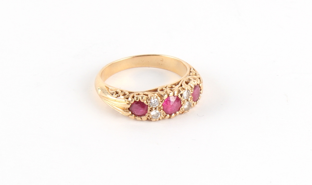 Property of a lady - an 18ct yellow gold ruby & diamond seven stone ring, the centre round cut