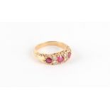 Property of a lady - an 18ct yellow gold ruby & diamond seven stone ring, the centre round cut