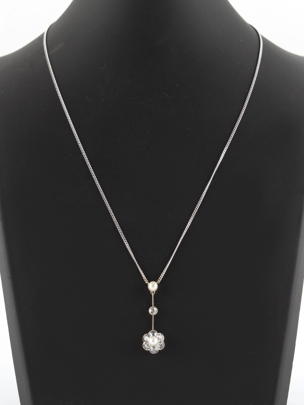 A diamond & pearl articulated pendant on 18ct white gold chain necklace, the seven old cut