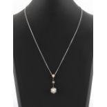 A diamond & pearl articulated pendant on 18ct white gold chain necklace, the seven old cut