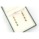 A pair of unmarked yellow gold emerald & diamond articulated pendant earrings, each 42mm long (2).