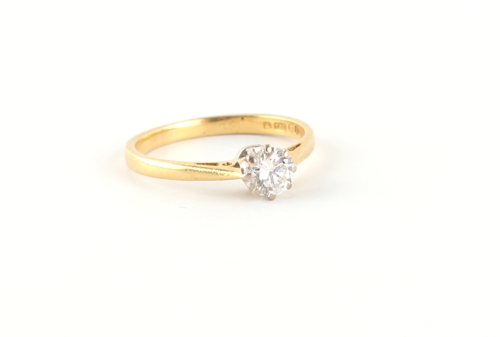 An 18ct yellow gold diamond single stone ring, the round brilliant cut diamond weighing